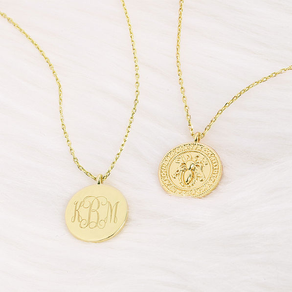 bee pendant necklace on fur rug