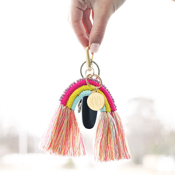 girl holding rainbow keychain