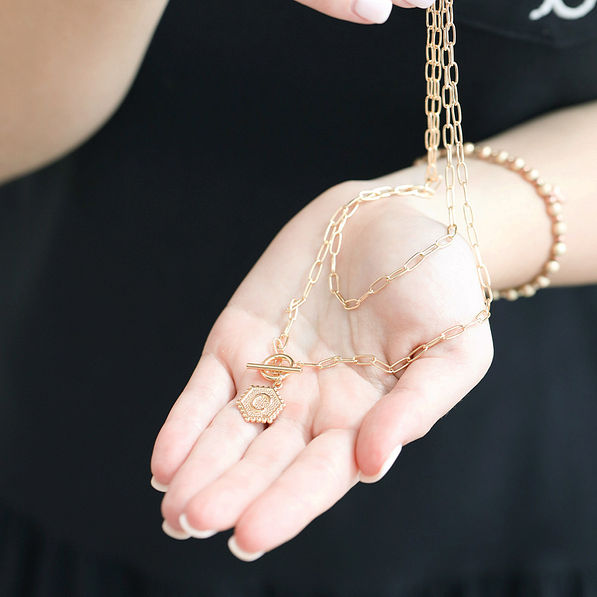initial necklace in hand