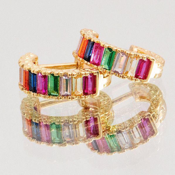 rainbow huggie hoop earrings on mirror