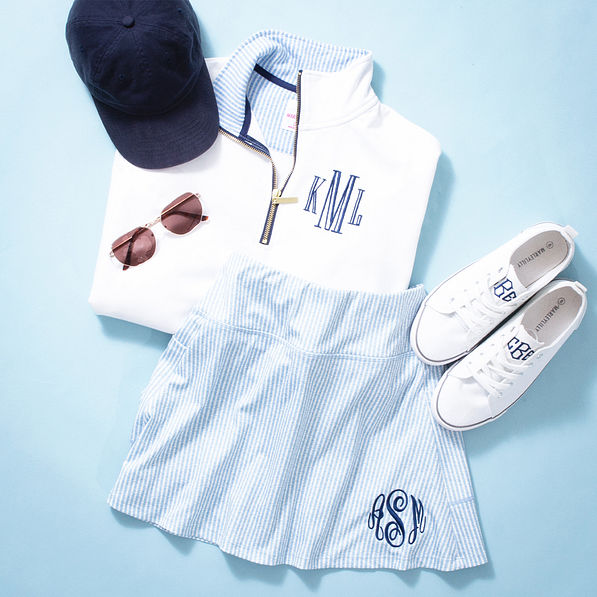 navy seersucker skort with quarter zip sweatshirt flatlay