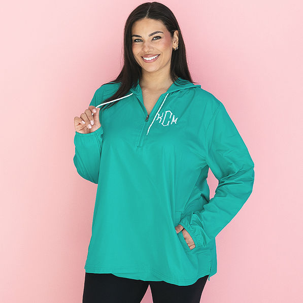 girl wearing teal monogrammed pullover rain jacket
