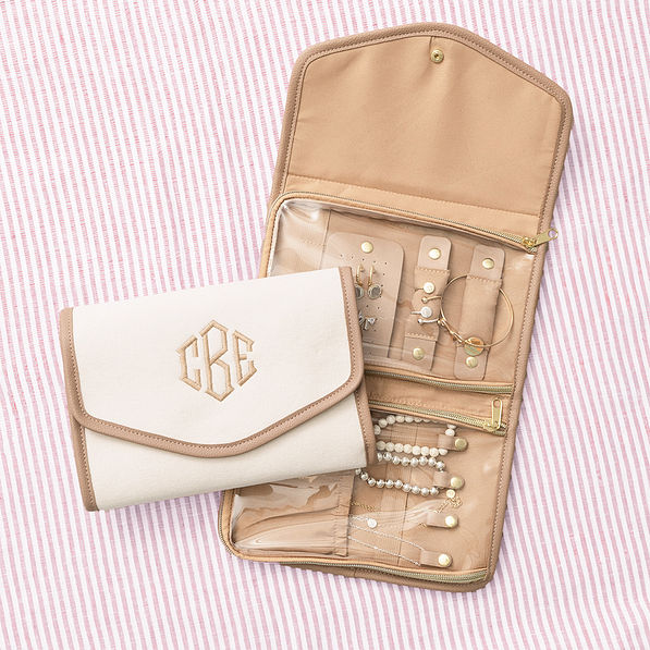 ivory travel jewelry organizer on pink striped background