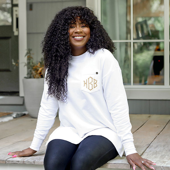 white crewneck sweatshirt on girl sitting on cabin porch new