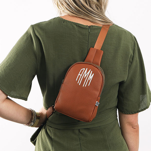 girl wearing brown sling bag  on back