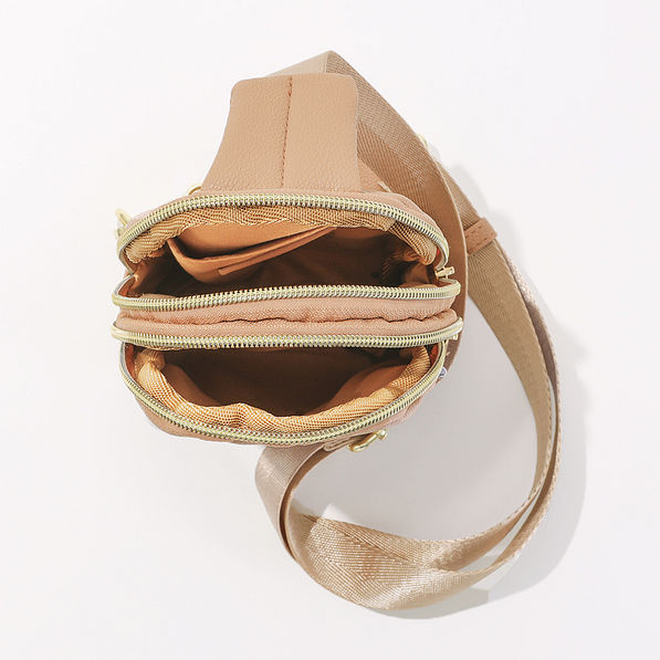 inside of tan sling bag
