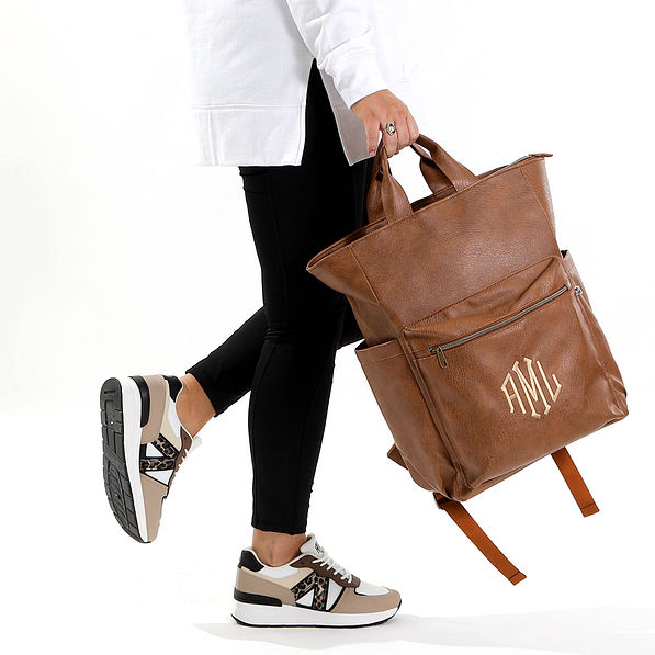 Brown commuter backpack swinging in studio