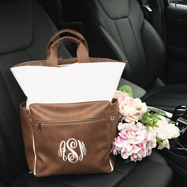 ivory commuter backpack in car with flowers