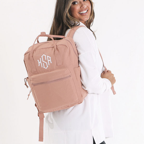 personalized canvas backpack in blush over shoulders