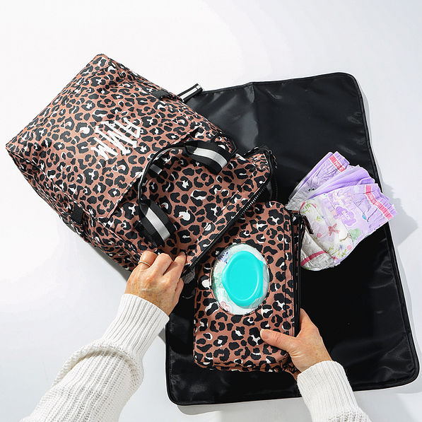 leopard diaper backpack with diaper changing carryall flatlay