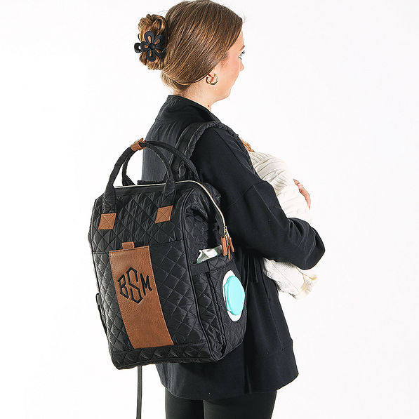 monogrammed diaper bag with baby in arms