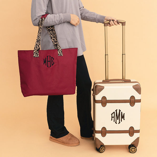 maroon monogrammed tote bag with luggage
