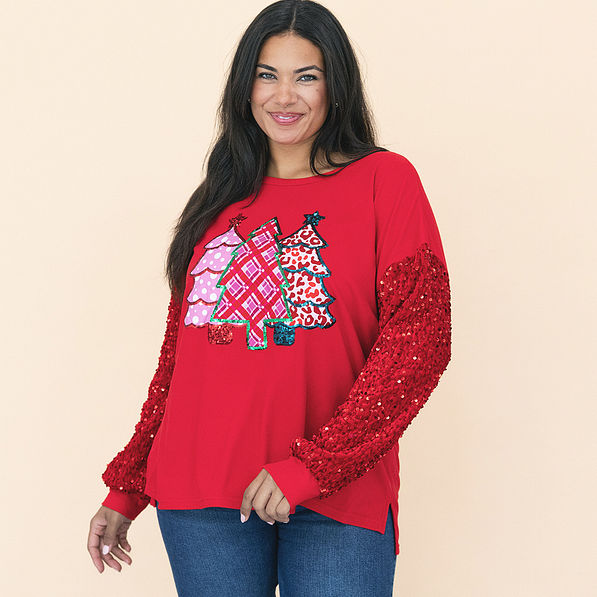 girl wearing red christmas sweatshirt