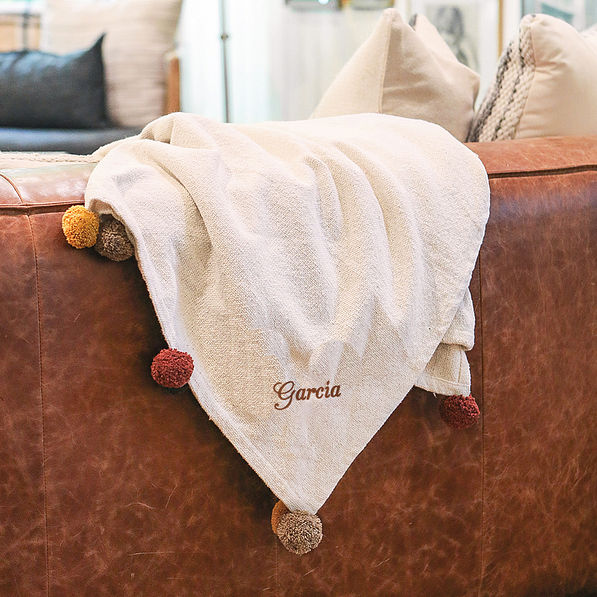 pom pom blanket on couch