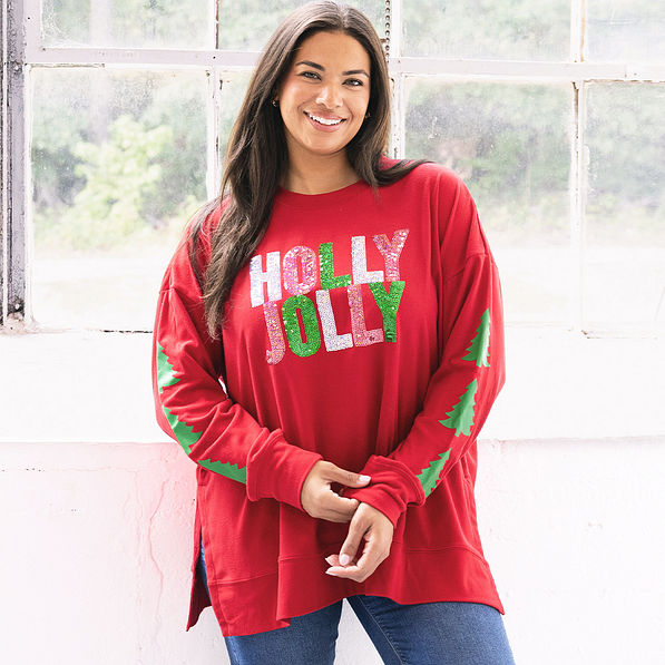 girl wearing christmas holly jolly crimson sweatshirt