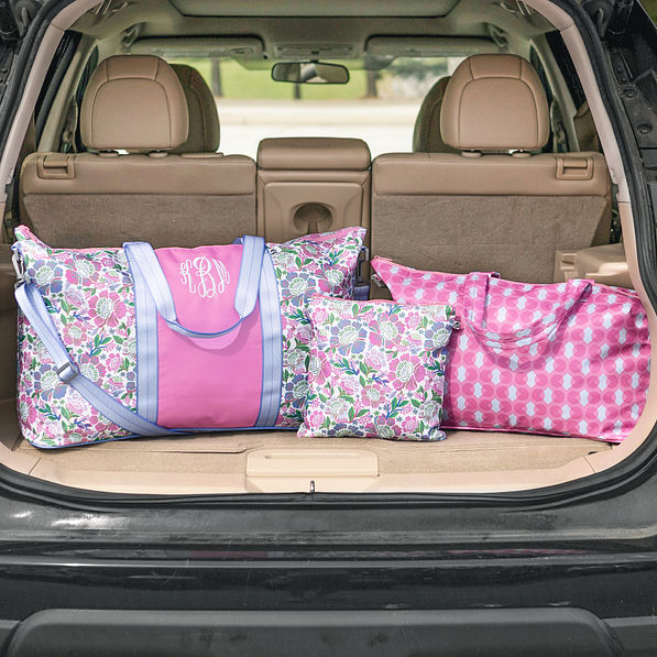orchid garden monogrammed travel bag sets in car trunk
