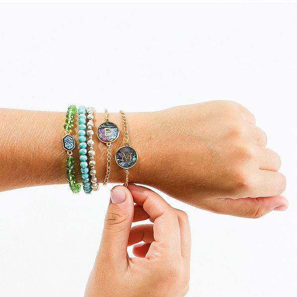 initial bracelet on arm