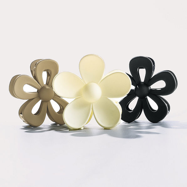 studio shot of neutral flower hair clips