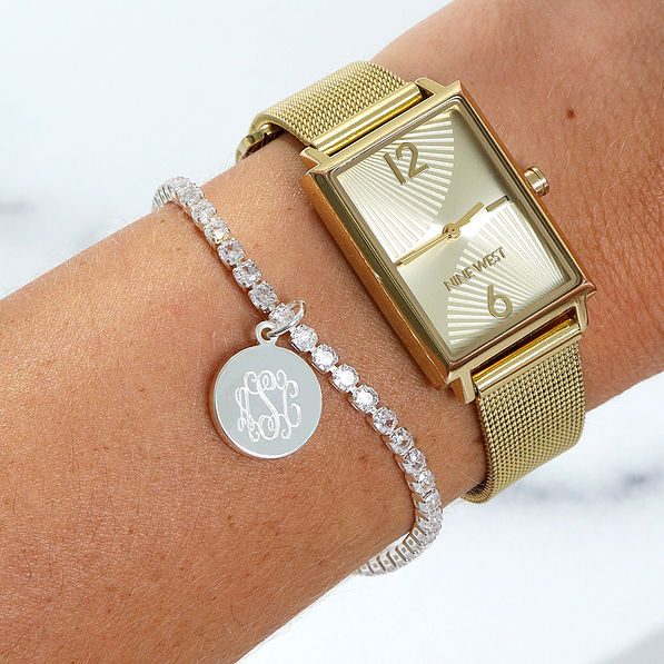 Silver personalized tennis bracelet on arm with watch