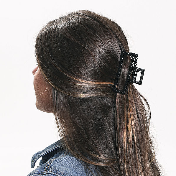 brunette wearing black beaded claw clip