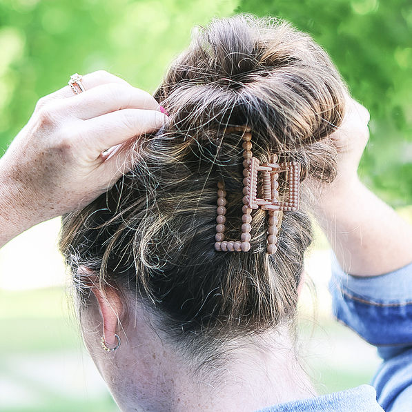 close up of brunette wearing mauve claw clip