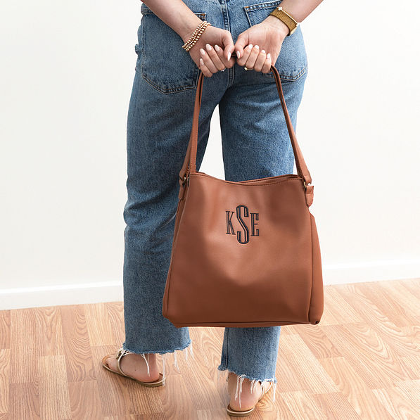 brown hobo purse in hands