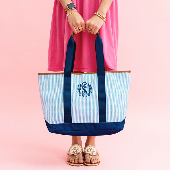 blue seersucker boat tote in hands