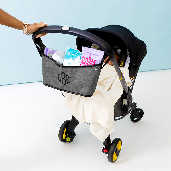 monogrammed heathered grey stroller caddy on stroller with baby