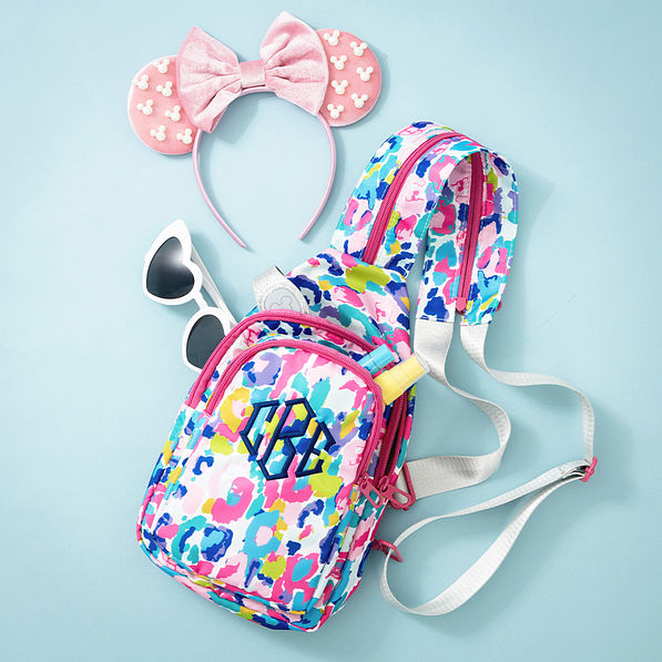 watercolor cheetah sling backpack flatlay on blue background