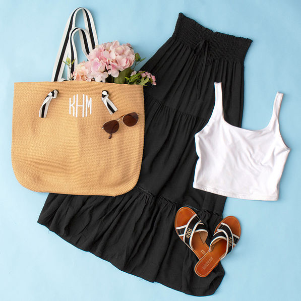 black midi skirt flatlay on blue paper