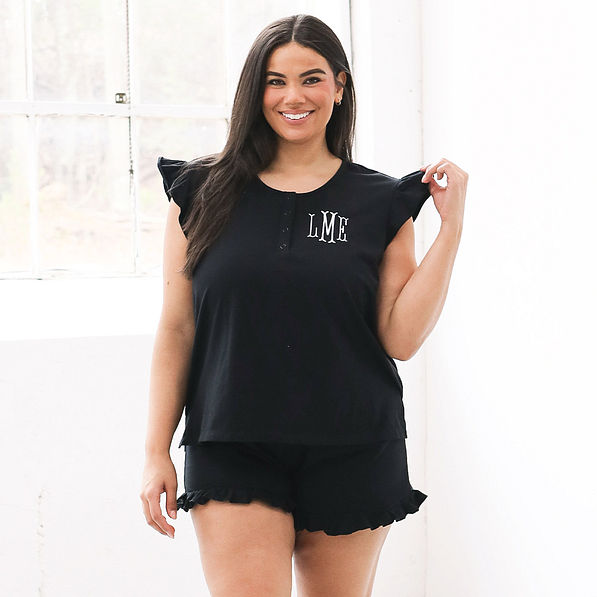 plus size model in black ruffle pajamas