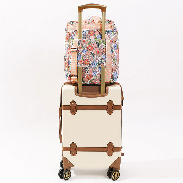 packable backback shown on a suitcase