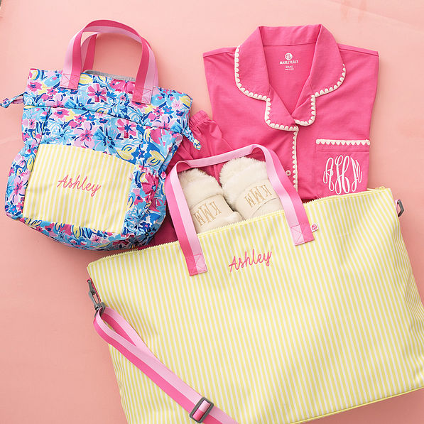 monogrammed toiletry bag in watercolor whimsy with monogrammed weekend bag in sunshine stripes
