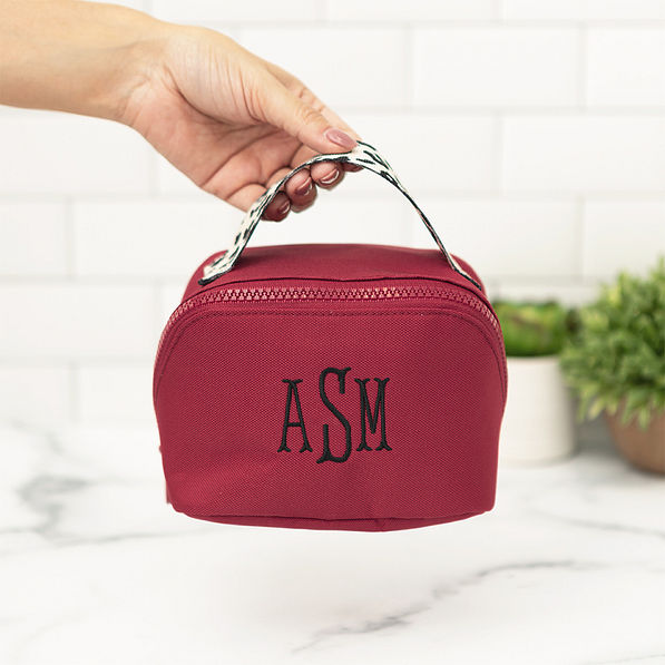 maroon makeup bag in hand