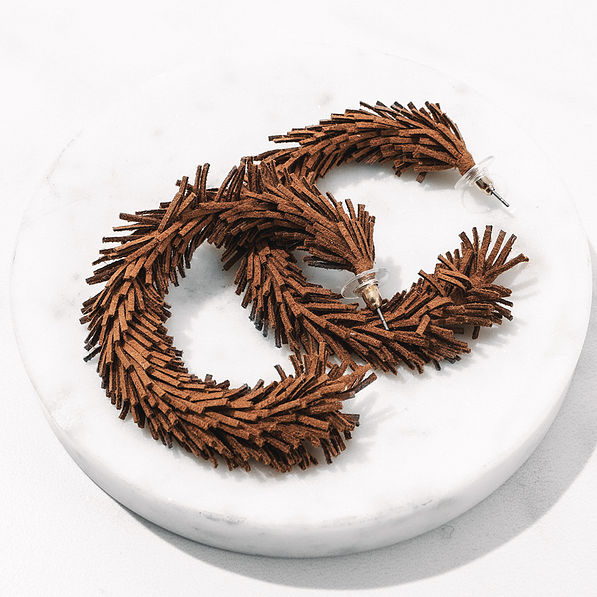 fringe hoop brown earrings on marble