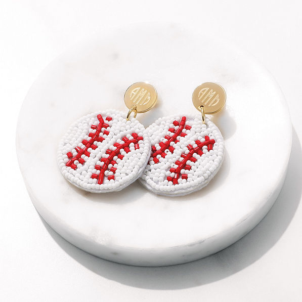baseball earrings on white marble