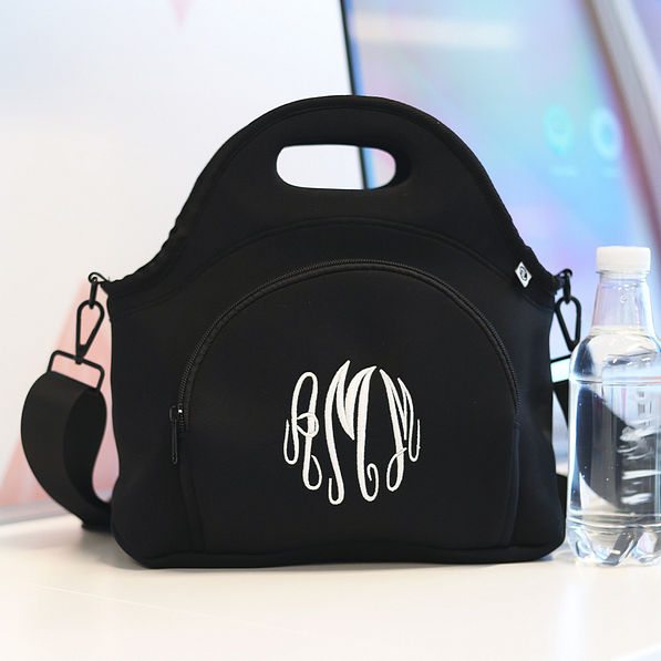 black neoprene lunch bag on desk