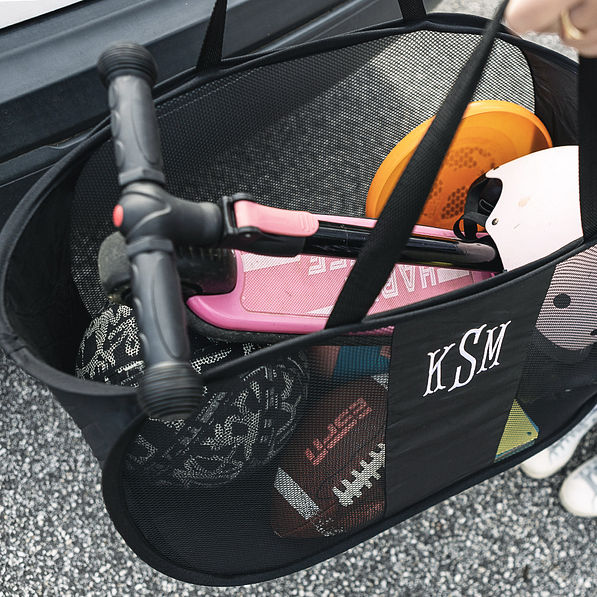 inside of black personalized pop up bag with kids outdoor toys