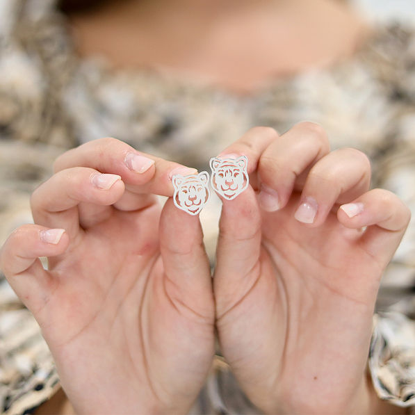 silver earrings in hands