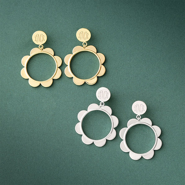 silver and gold scallop earrings on green paper