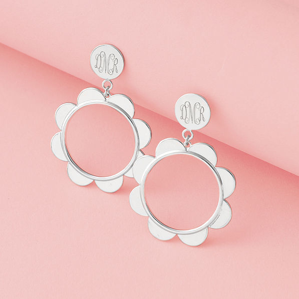 silver scallop earrings on pink paper