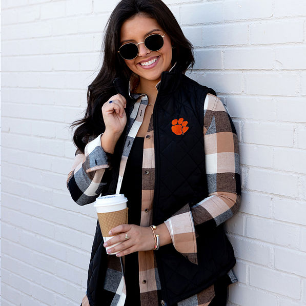 Brunette wearing black clemson puffer vest