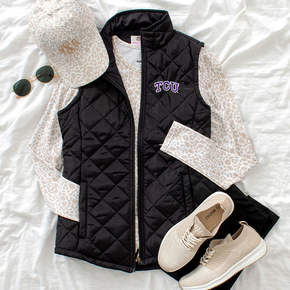 tcu puffer vest flatlay leopard hat sneakers shirt
