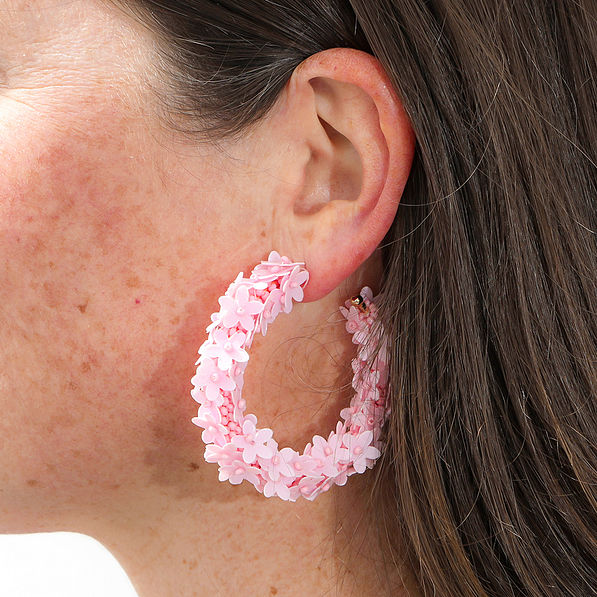 pink flower hoop earrings in ear