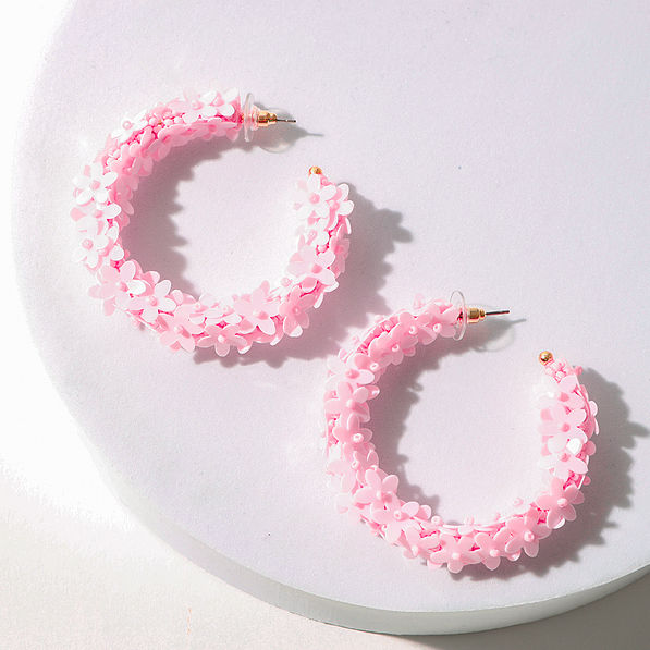 pink flower hoop earrings in studio