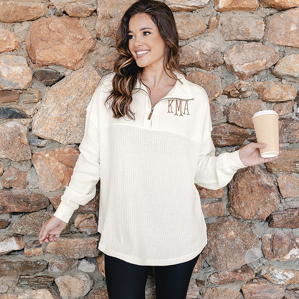 girl wearing monogrammed ivory waffle knit pullover with leggings