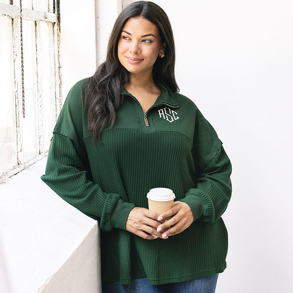 girl wearing pine monogrammed waffle knit pullover with jeans