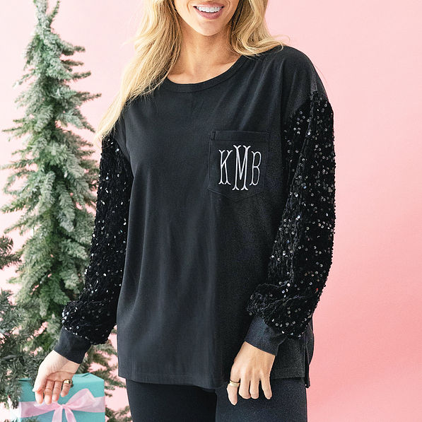 close up of monogrammed black sequin sleeve sweatshirt