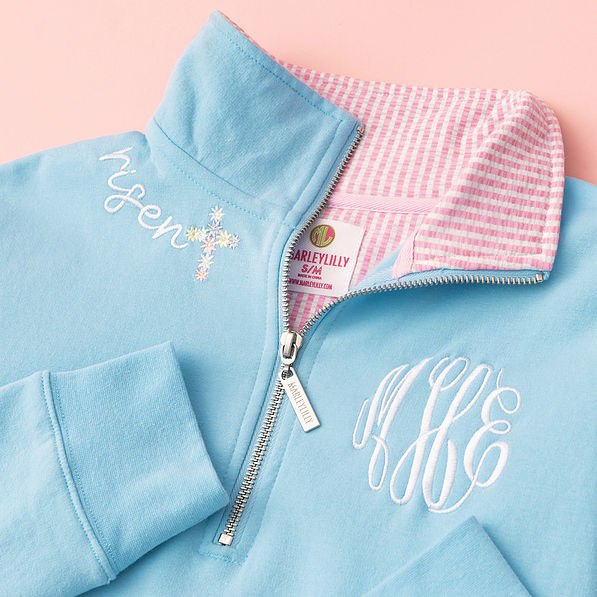 close up of embroidery on faith pullover in blue and pink seersucker