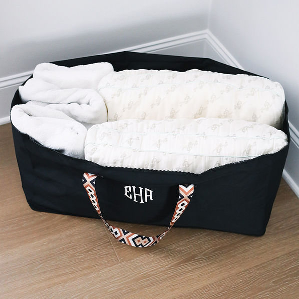 monogrammed foldable storage bag with towels and pillows